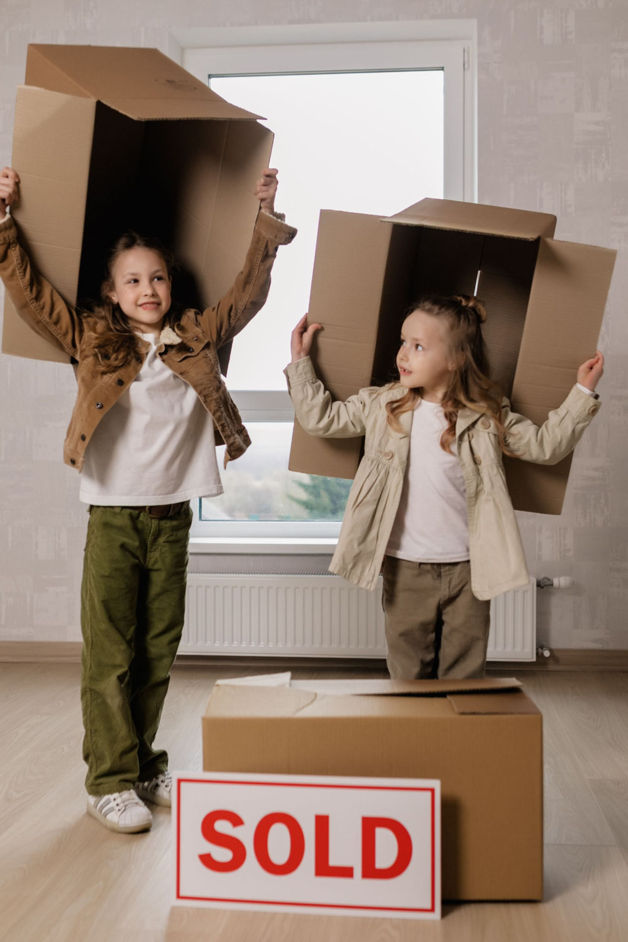 Family moving into a newly purchased home marked sold